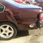 Before and after photographs of a damaged Chevy Impala that was repaired by Elite Paint & Body Shop in West Palm Beach, Florida.